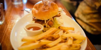 close up of a plate with burger and fries