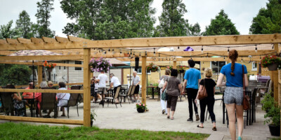 people gathering under a pergola