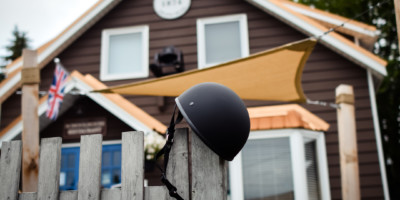 motorbike helmet hung from a gate post