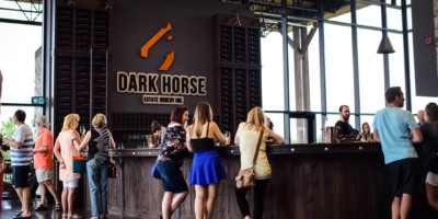 People tasting wine at a wine bar at Dark Horse Estate Winery