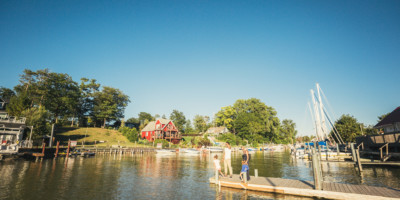 LOCATION: GRAND BEND, ON Family at the end of a dock where boats are parked in Grand Bend