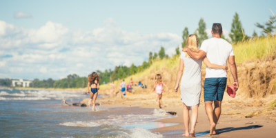 LOCATION: GRAND BEND, ON Couple walking along the beach in Grand Bend