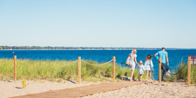 LOCATION: SARNIA, ON Family walking towards the beach at Canatara Park Sarnia