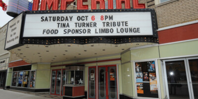 Marquee sign and entrance at Imperial Theater showing show times