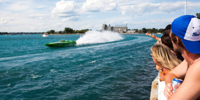 Crowd watching a power boat turn during the International Power Boat Festival