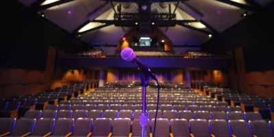View of seats from behind a microphone on stage of the Victoria Playhouse