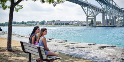 Mother and two daughters sitting under the bluewater bridge