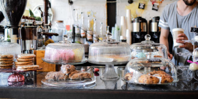 Variety of pastries under glass covers at Blackwater Coffee Company